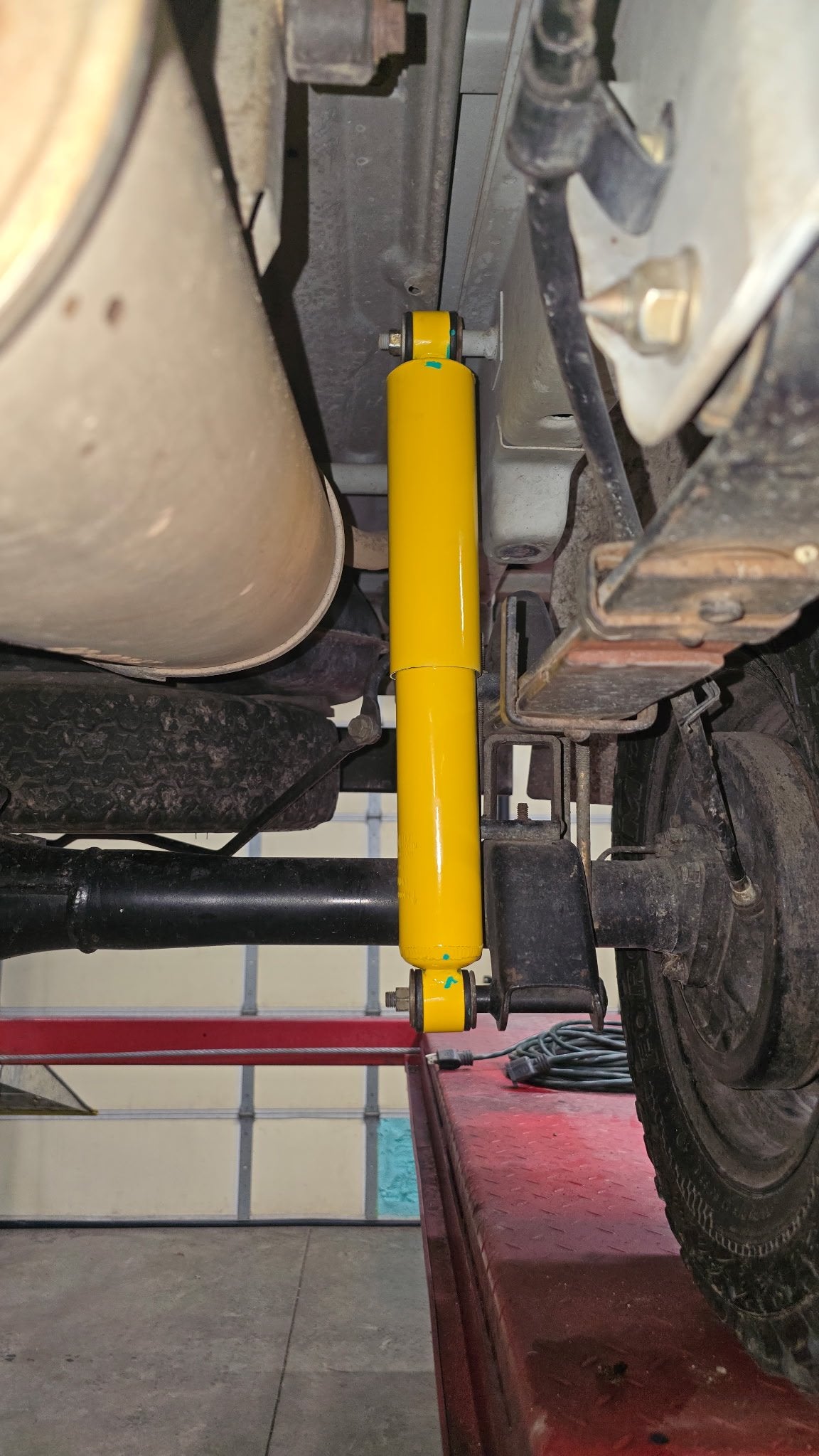 Extended rear shock installed — close-up